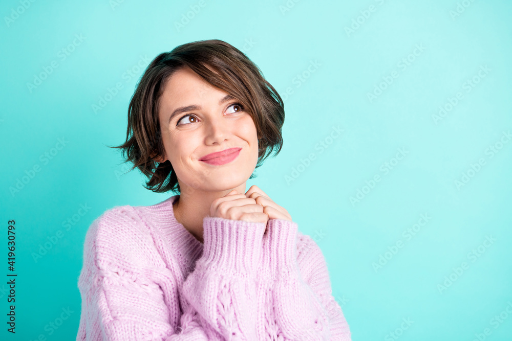 Photo of pretty thoughtful young woman wear violet sweater looking empty space isolated turquoise color background Photo of pretty thoughtful young woman wear violet sweater looking empty space isolated turquoise color background