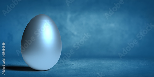 Easter 3D render concept  A single decorative glossy and silver metallic egg on blue background with smooth shadow and large copy space. Illustrated graphic object. Bright shiny surface