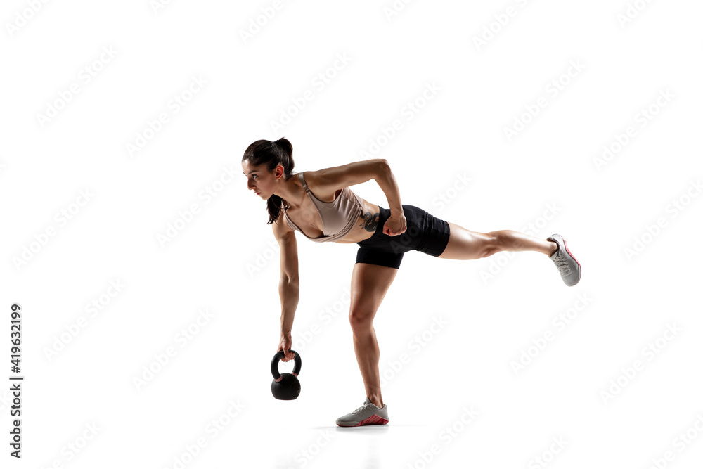 Balance. Caucasian professional female athlete training isolated on white studio background. Muscular, sportive woman. Concept of action, motion, youth, healthy lifestyle. Copyspace for ad. Balance. Caucasian professional female athlete training isolated on white studio background. Muscular, sportive woman. Concept of action, motion, youth, healthy lifestyle. Copyspace for ad.