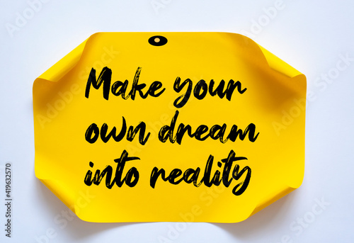 Text make your own dream into reality on the short note texture background