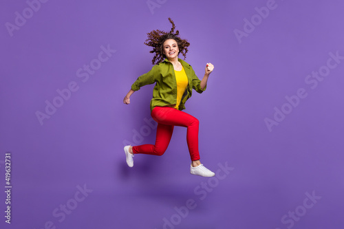 Full size photo of young happy positive smiling attractive lovely girl running in air isolated on purple color background