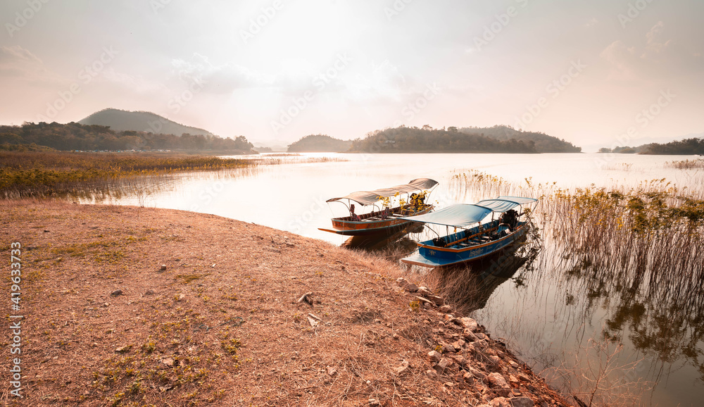 Thai traditional wooden longtail boat and beautiful River, sky, mountains. Thai traditional wooden longtail boat and beautiful River, sky, mountains.