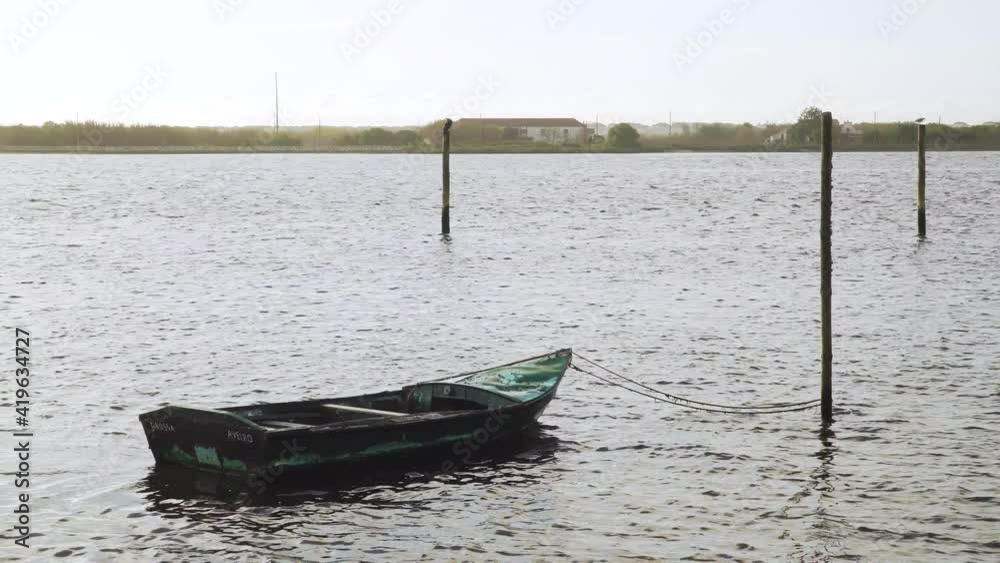4K wooden boat moored in Ria de Aveiro, old boat moving on the river current. 60fps 4K wooden boat moored in Ria de Aveiro, old boat moving on the river current. 60fps