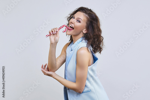 attractive thoughtful girl sucks a Lollipop