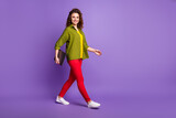 Full size photo of positive girl hold laptop go walk copyspace partnership meeting wear good look outfit gumshoes isolated over violet color background