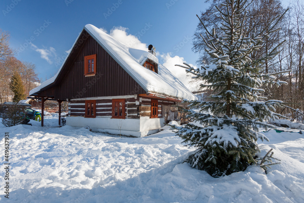 Traditional wooden cottage in winter.