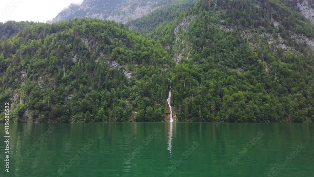 Summer landscape with Konigssee deep lake and Alp mountains with waterfall in Berchtesgadener Land, Germany Summer landscape with Konigssee deep lake and Alp mountains with waterfall in Berchtesgadener Land, Germany