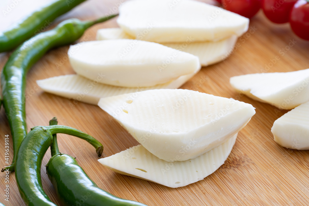 Close-up cheese on wooden background. Local name lavaş peyniri Close-up cheese on wooden background. Local name lavaş peyniri