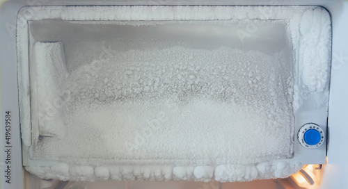 freezer of a refrigerator. Ice buildup inside of a freezer walls.