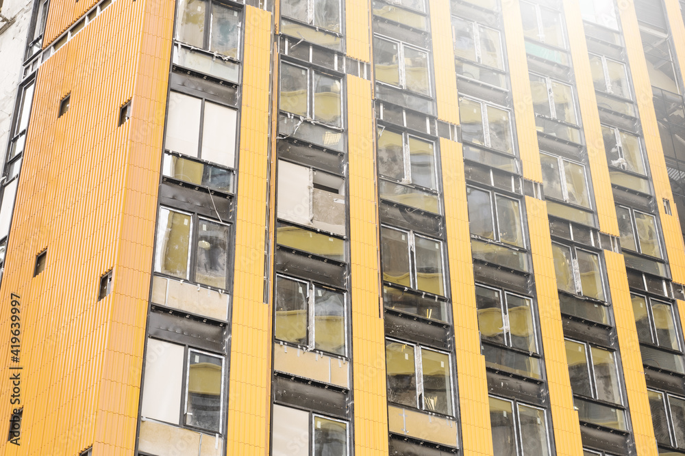 Yellow facade of a multi-storey apartment building under construction