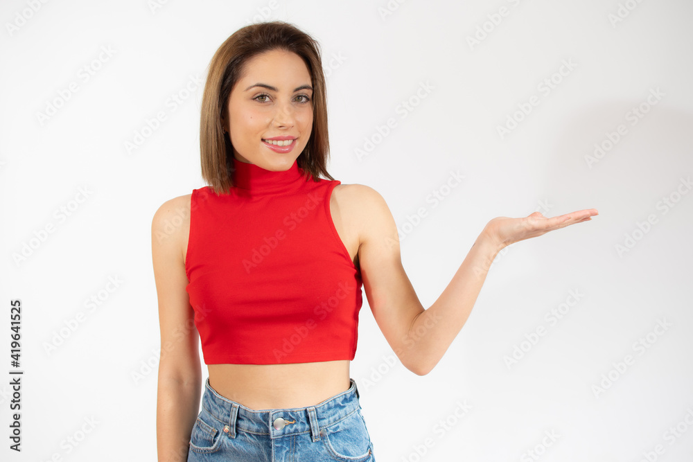 Happy woman presenting with open hand holding something blank isolated over white background Happy woman presenting with open hand holding something blank isolated over white background