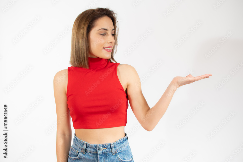 Happy woman presenting with open hand holding something blank isolated over white background Happy woman presenting with open hand holding something blank isolated over white background