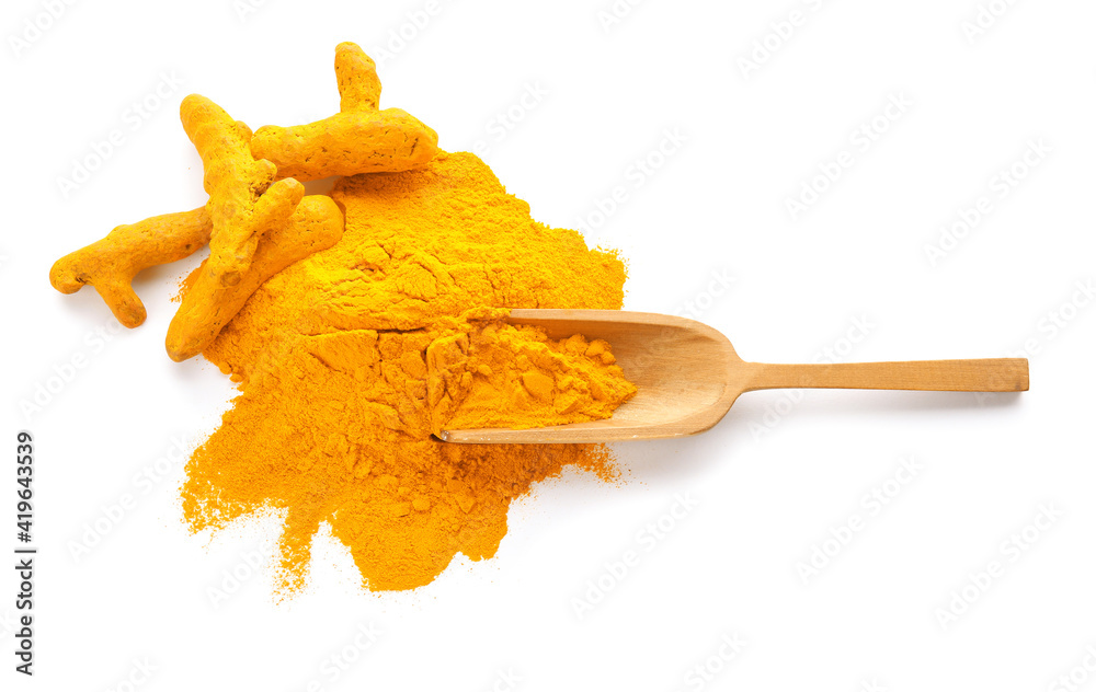 Naklejka premium Scoop with turmeric powder on white background