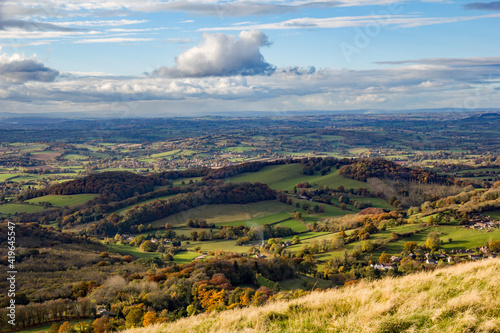 Rolling hills and seasonal oranges and browns on this fall or autumnal image of English countryside in the Malvern Hills, Worcestershire photo