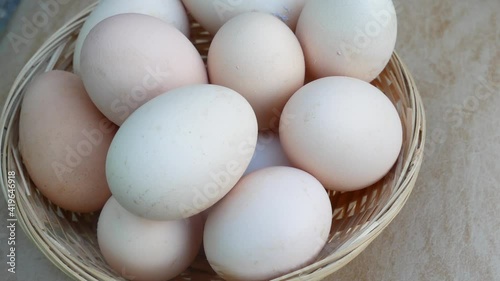 fresh eggs in basket on wooden background