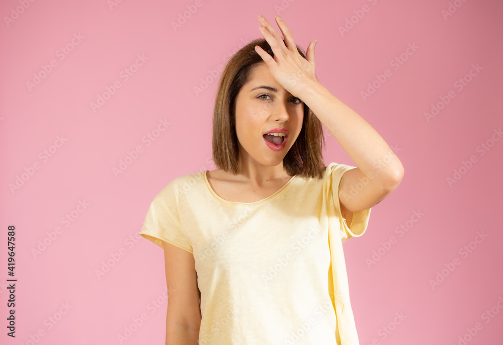Close-up portrait of young pretty surprised woman with opened mouth standing with open palms, isolated over pink background Close-up portrait of young pretty surprised woman with opened mouth standing with open palms, isolated over pink background