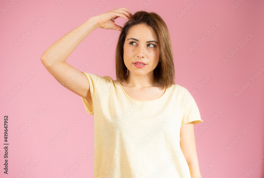 Portrait of a pensive casual woman looking away at copy space isolated over pink background Portrait of a pensive casual woman looking away at copy space isolated over pink background