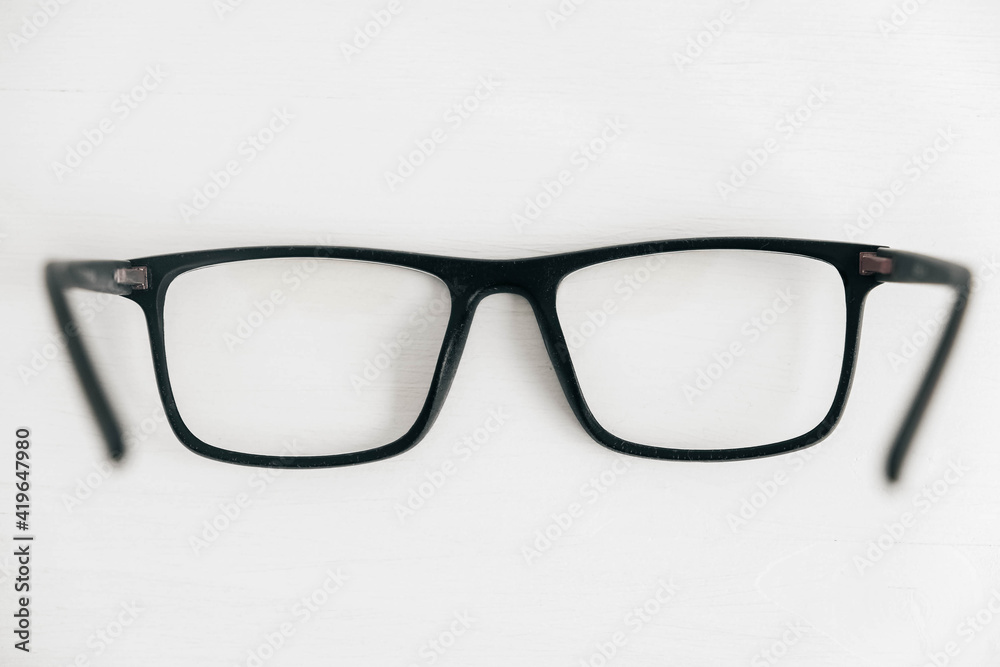 Optical glasses in a dark frame on a white background. Copy, empty space for text Optical glasses in a dark frame on a white background. Copy, empty space for text