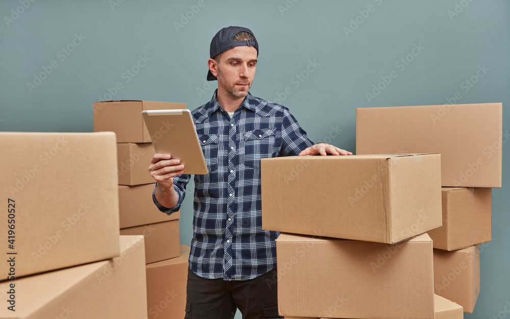 Man in warehouse with cardboard boxes Man in warehouse with cardboard boxes