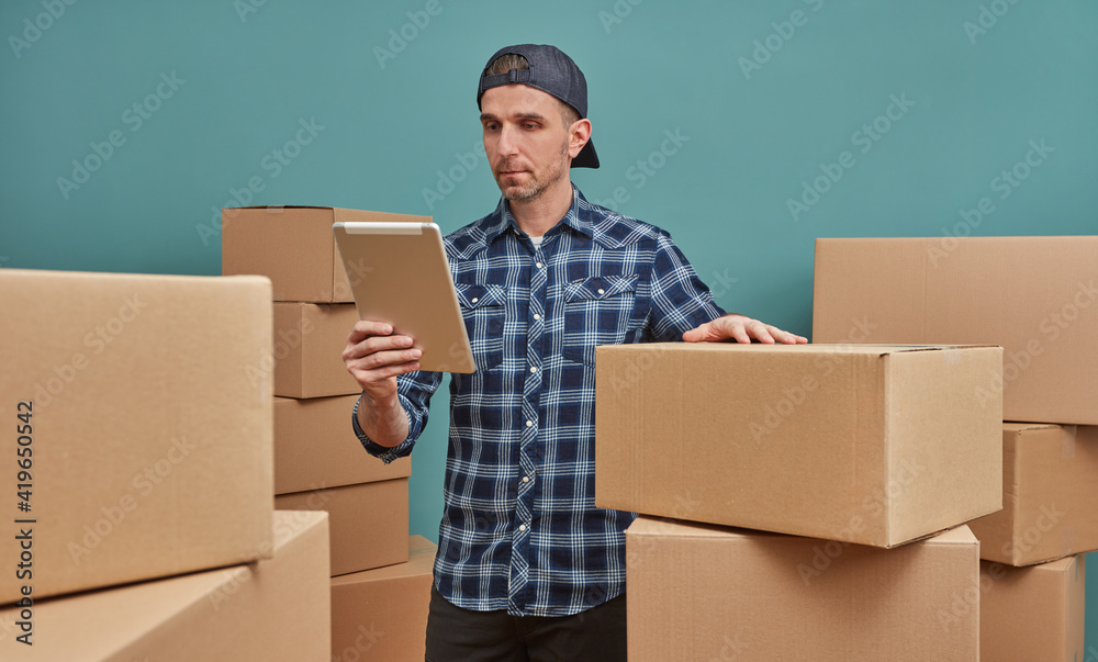Man at warehouse looking at digital tablet Man at warehouse looking at digital tablet