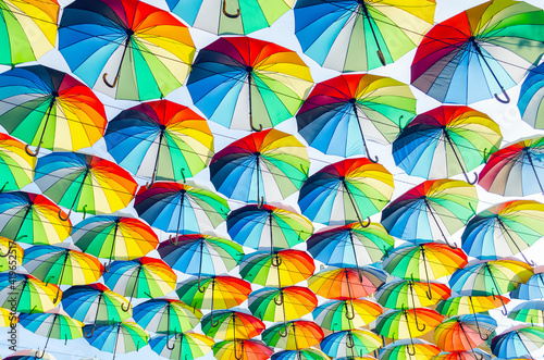 Hanging multicolored colorful umbrellas adorn the alley  street decoration