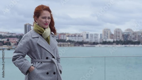 Medium shot a girl talking on the phone against the backdrop of the city landscape