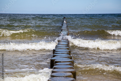Breaking waves on the wooden planks at the Baltic Sea..