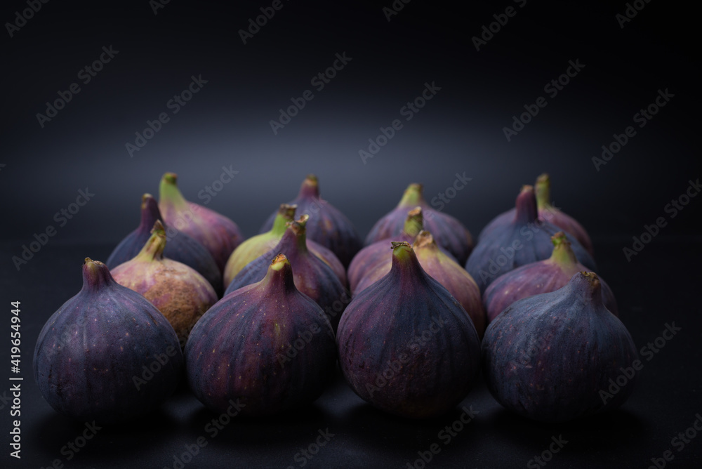 Tasty figs on a black background. Top view. Tasty figs on a black background. Top view.