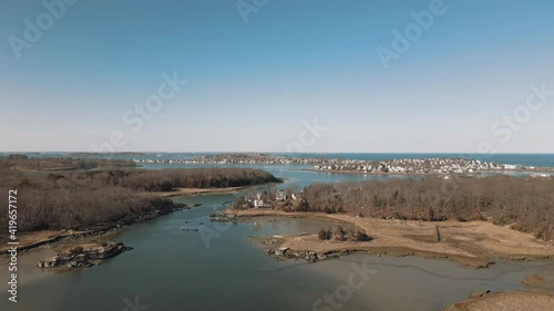 Aerial pullback elevating shot of a salt marsh between Hingham's World End neighborhood and Hull, MA. Drone. 4k photo