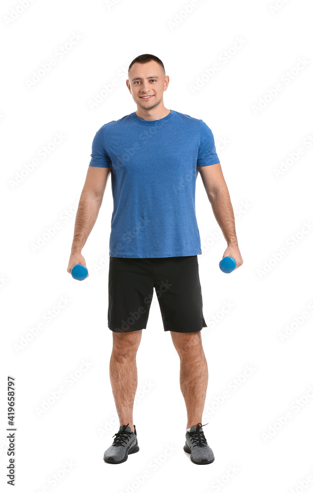 Handsome young man training with dumbbells on white background