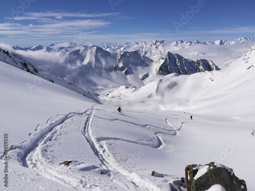 SKIMO, Ski Mountaineering, Ski tour. First line in deep snow. Powder run over gotthardpass. Perfect winter weather. photo