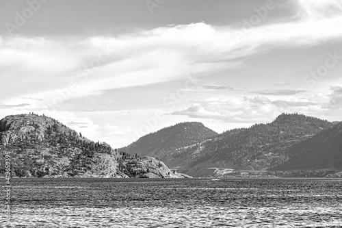 Scenery view of rocky slope over the lake in black and white