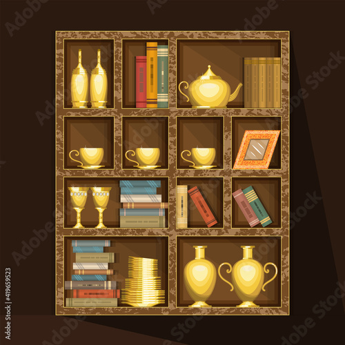 Large wooden rack with gold dishes and books. On the shelves are plates, glasses, cups, teapot, bottles, hardcover books and more