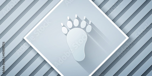 Paper cut Bear paw footprint icon isolated on grey background. Paper art style. Vector.