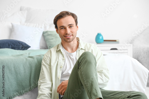 Smiling young man relaxing ...