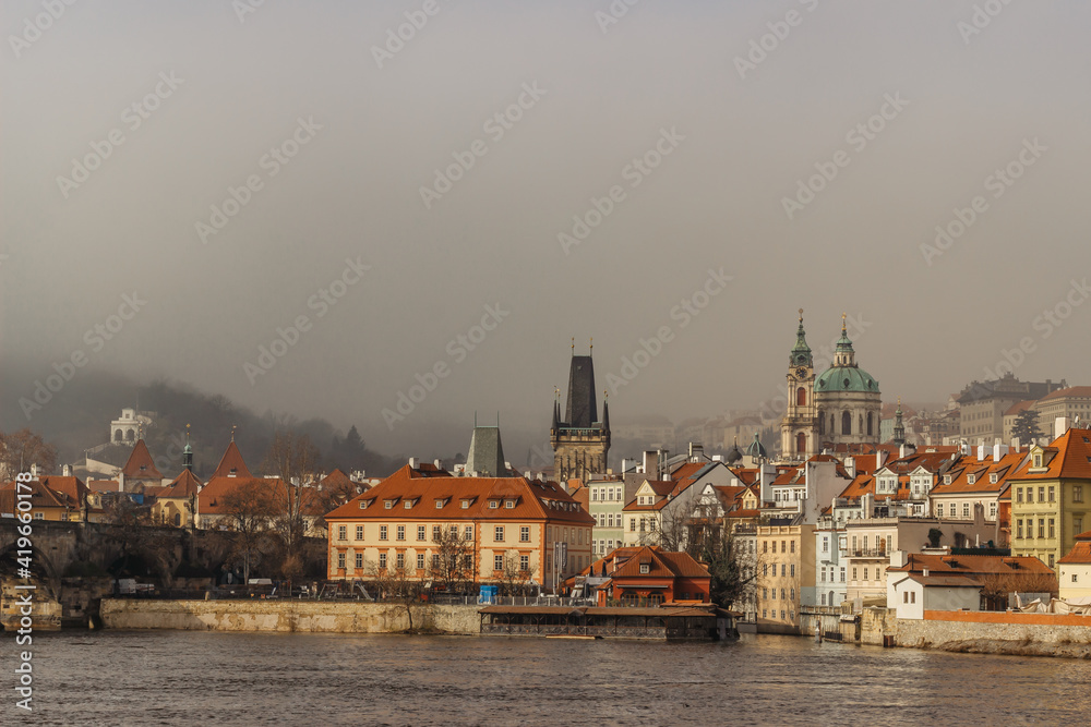 Postcard view of Lesser Town in mist from Charles Bridge,Czech republic.Famous tourist destination.Prague panorama.Foggy morning in city.Amazing European cityscape inversion weather.Romantic trip