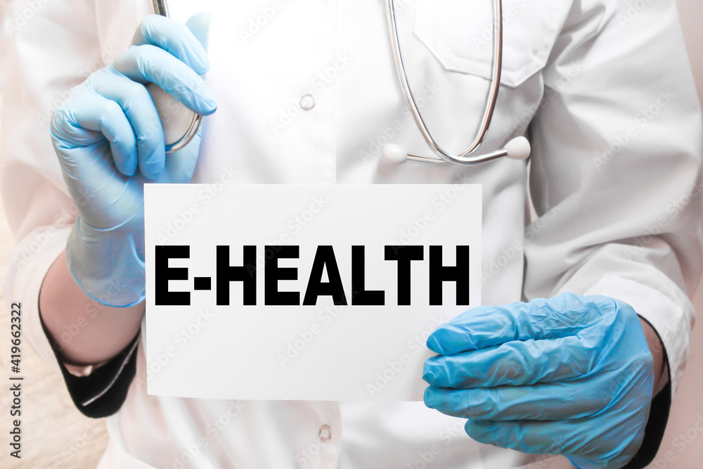 The doctor's blue - gloved hands show the word E-HEALTH - . a gloved hand on a white background. Medical concept. the medicine The doctor's blue - gloved hands show the word E-HEALTH - . a gloved hand on a white background. Medical concept. the medicine