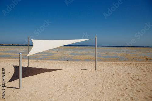 white beach awning on the Red Sea and blue sky