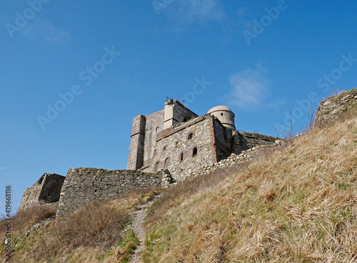 Castle and ancient military fortress on the top of a mountain.