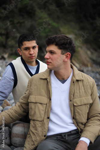 Portrait of a homosexual young couple on the beach loving each other