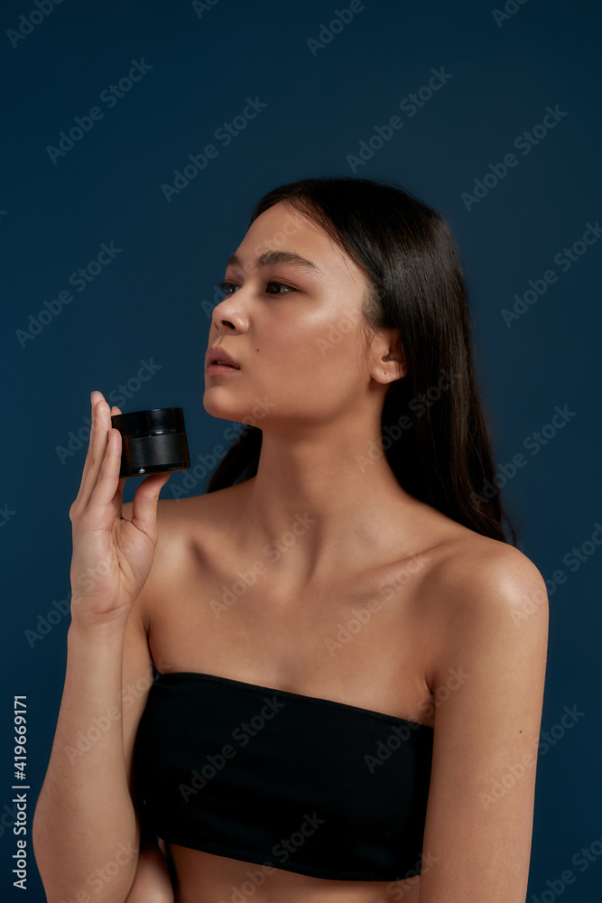 Young girl is posing with skin cream Young girl is posing with skin cream