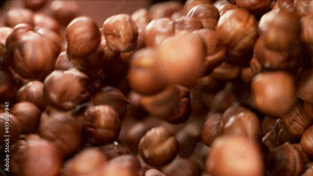 Super slow motion of flying hazelnuts in rotating movement. Filmed on high speed cinema camera, 1000fps.