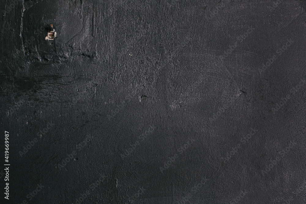 Naklejka premium Dark black grunge textured wall closeup macro