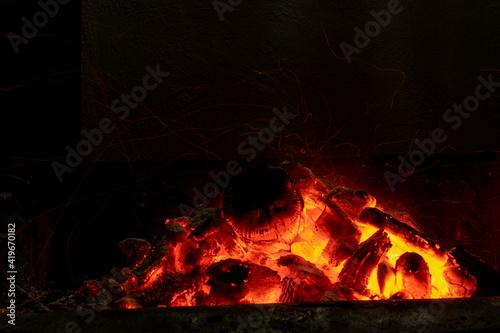 Obraz na plátně Incandescent charcoal ember in long exposure in orange and yellow tones