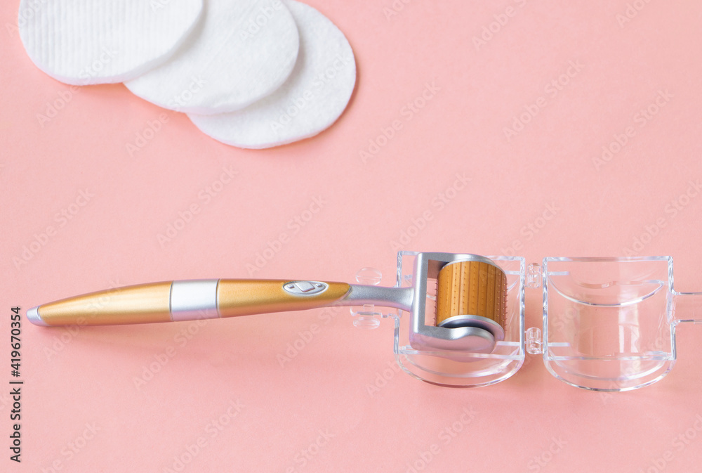 Cosmetological mesoscooter for home use. A tool for eliminating wrinkles. Anti age concept. High quality photo Cosmetological mesoscooter for home use. A tool for eliminating wrinkles. Anti age concept. High quality photo