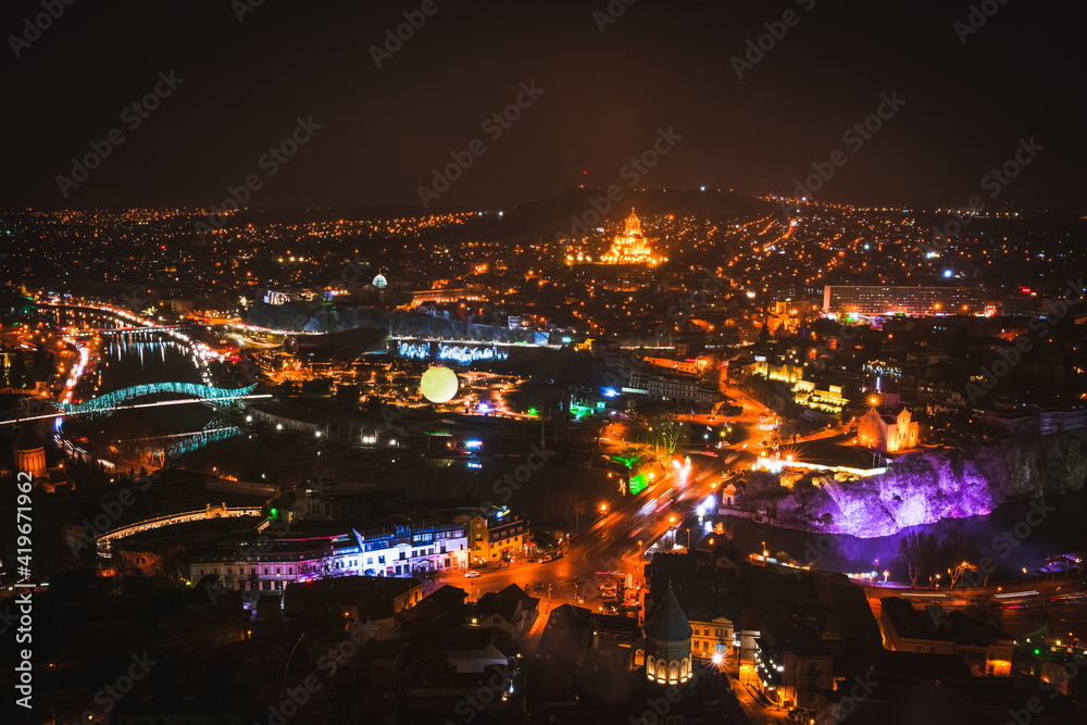 Tbilisi night city panorama with passing cars sightseeing attractions. Travel Georgia blank space background
