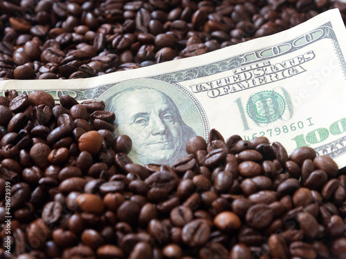 One hundred USA Dollars  bill closeup among coffee beans background