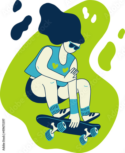 Girl with long hair jumping on a skateboard, holding a skateboard with her hand, on a green background