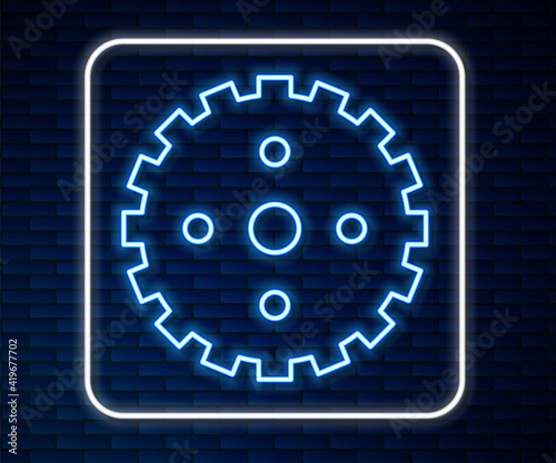 Glowing neon line Bicycle sprocket crank icon isolated on brick wall background. Vector.