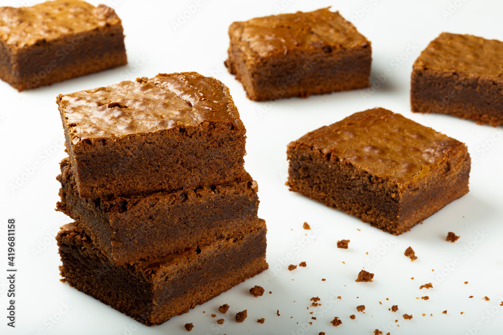Delicious pieces of fresh brownie on white background. Chocolate pie. Delicious pieces of fresh brownie on white background. Chocolate pie.